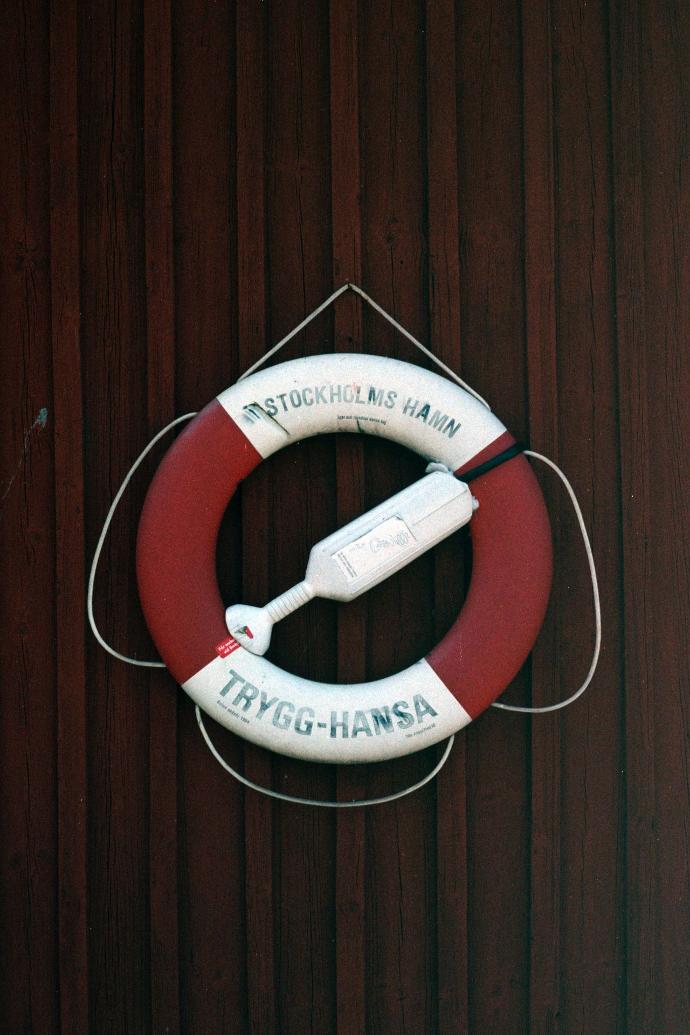 a life preserver hanging on a wooden wall